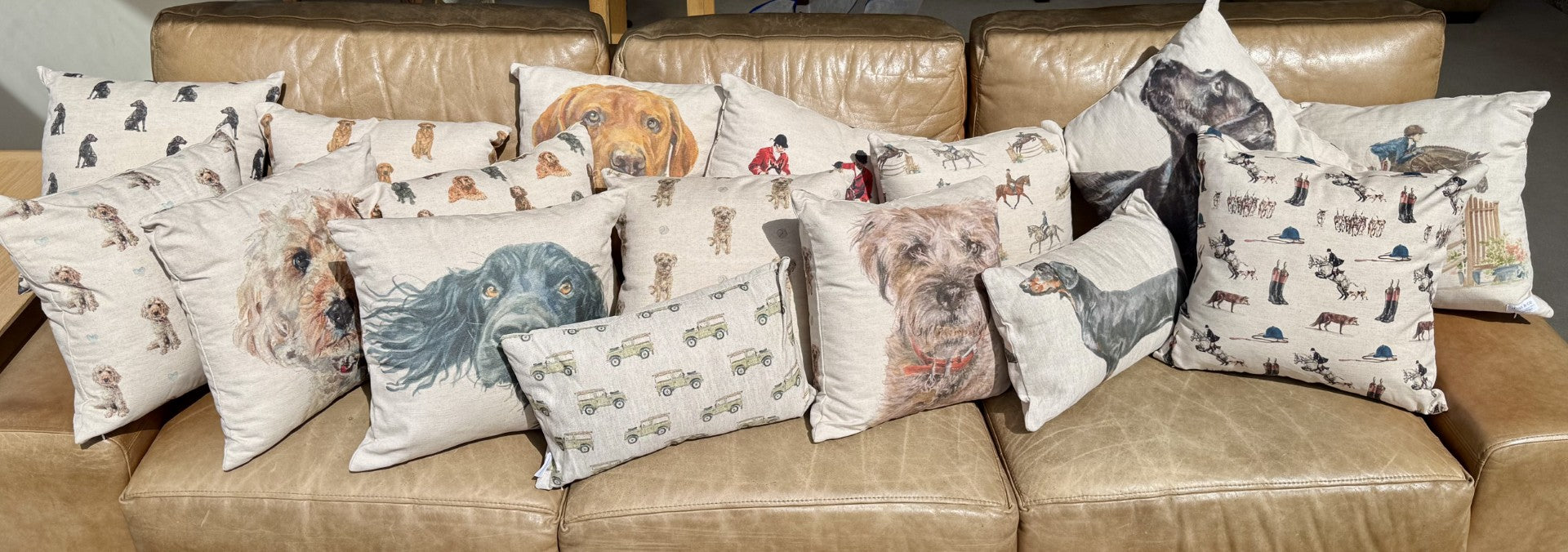 **A collection of country-themed decorative cushions featuring dog portraits, equestrian scenes, and rural lifestyle prints.**