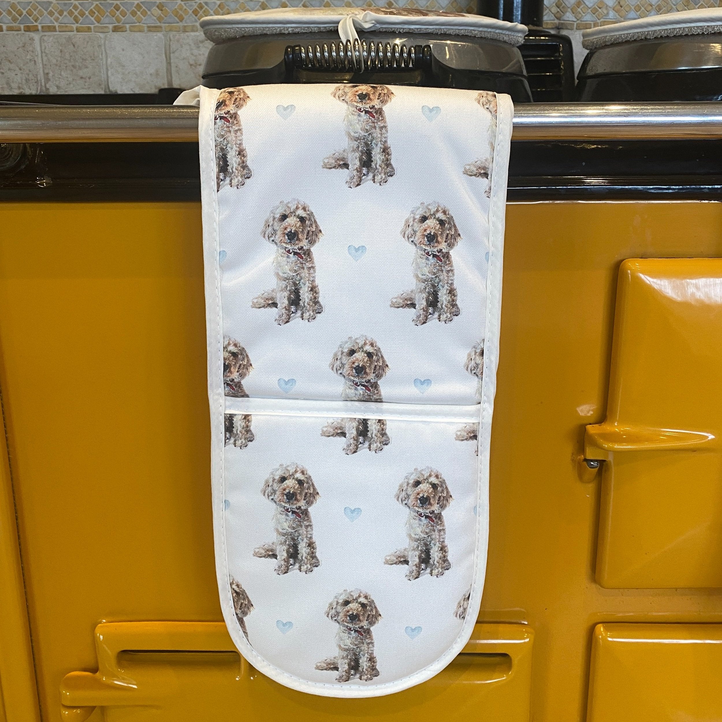 Cockapoo double oven gloves hanging in a kitchen