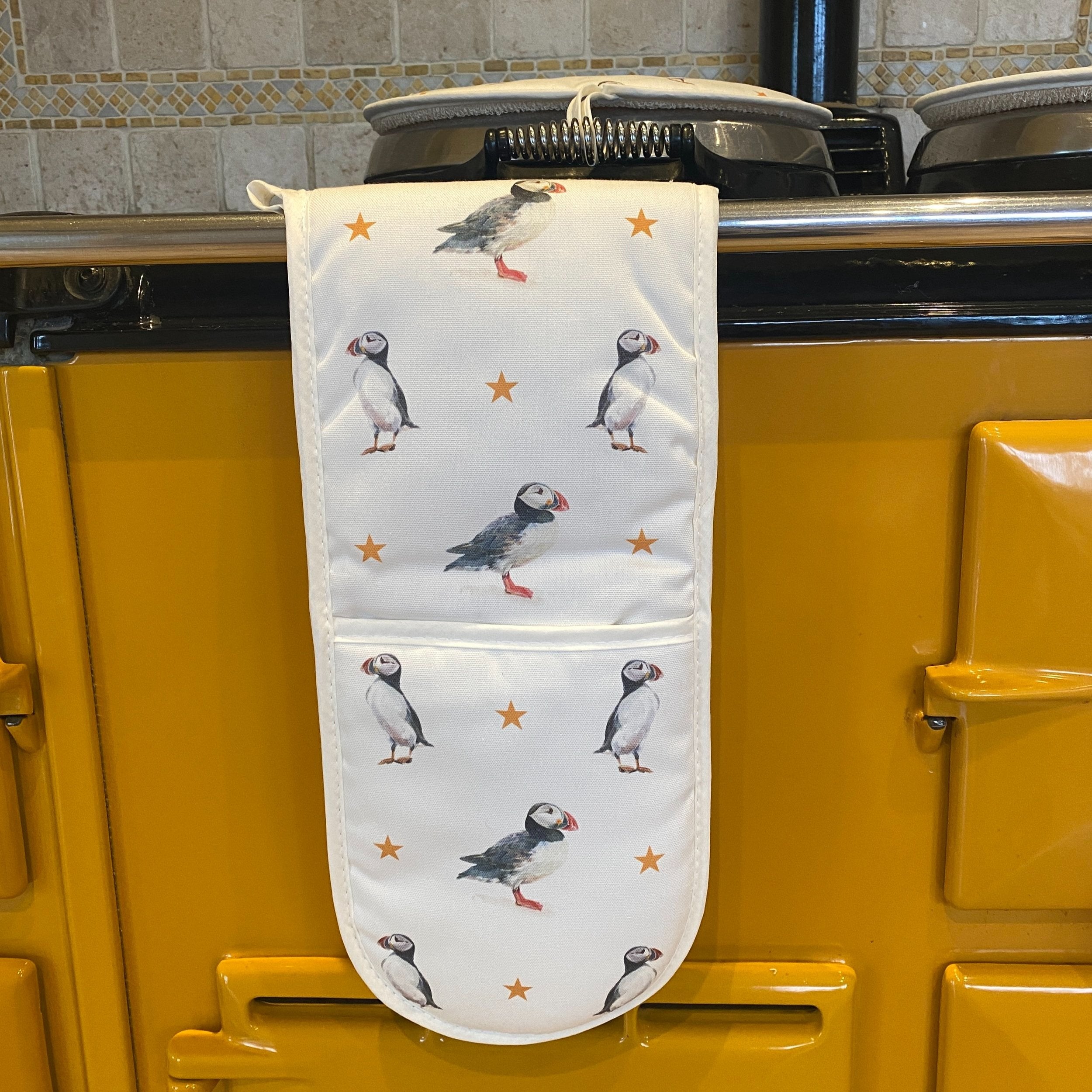 Puffins double oven gloves hanging in a kitchen