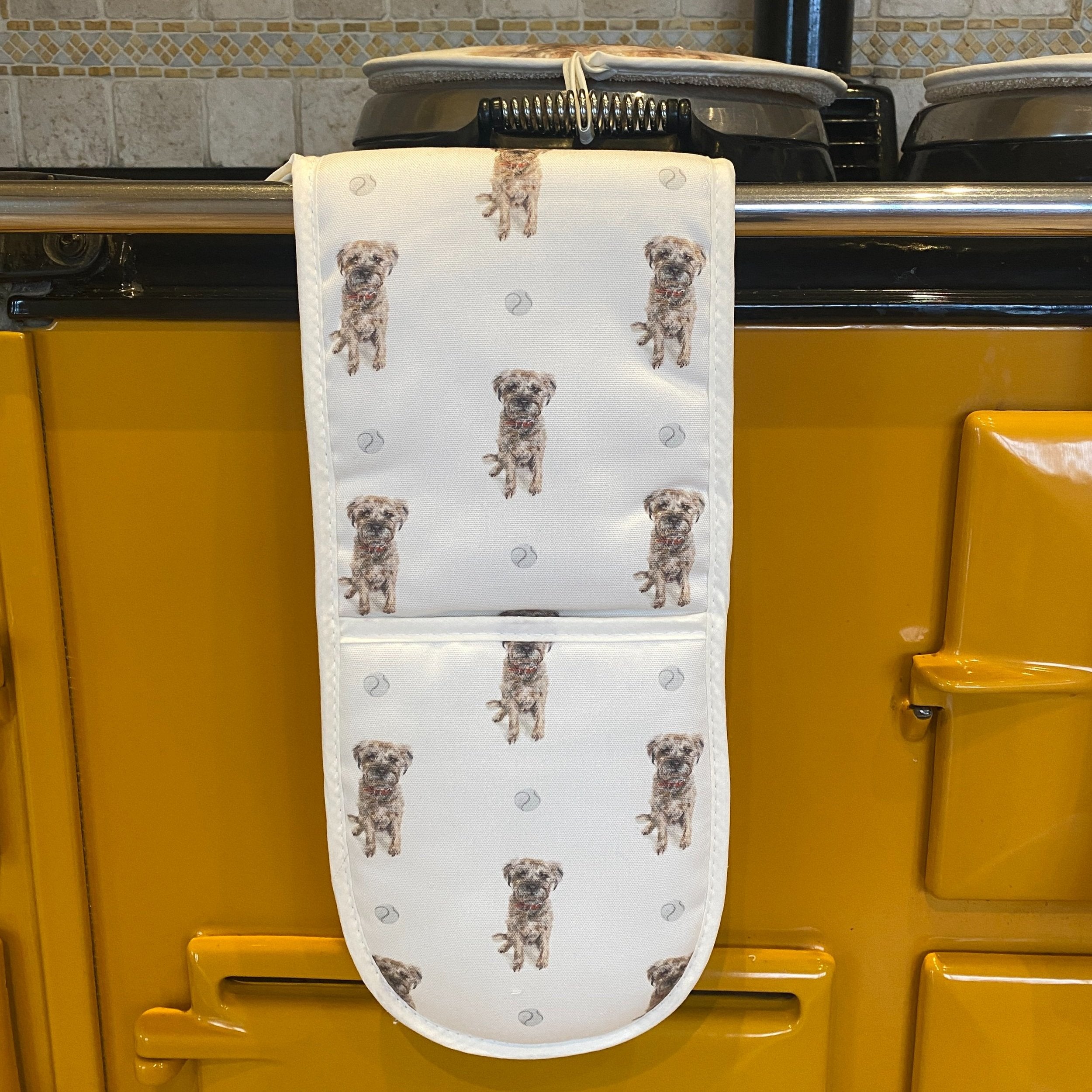 Border Terrier double oven gloves hanging in a kitchen