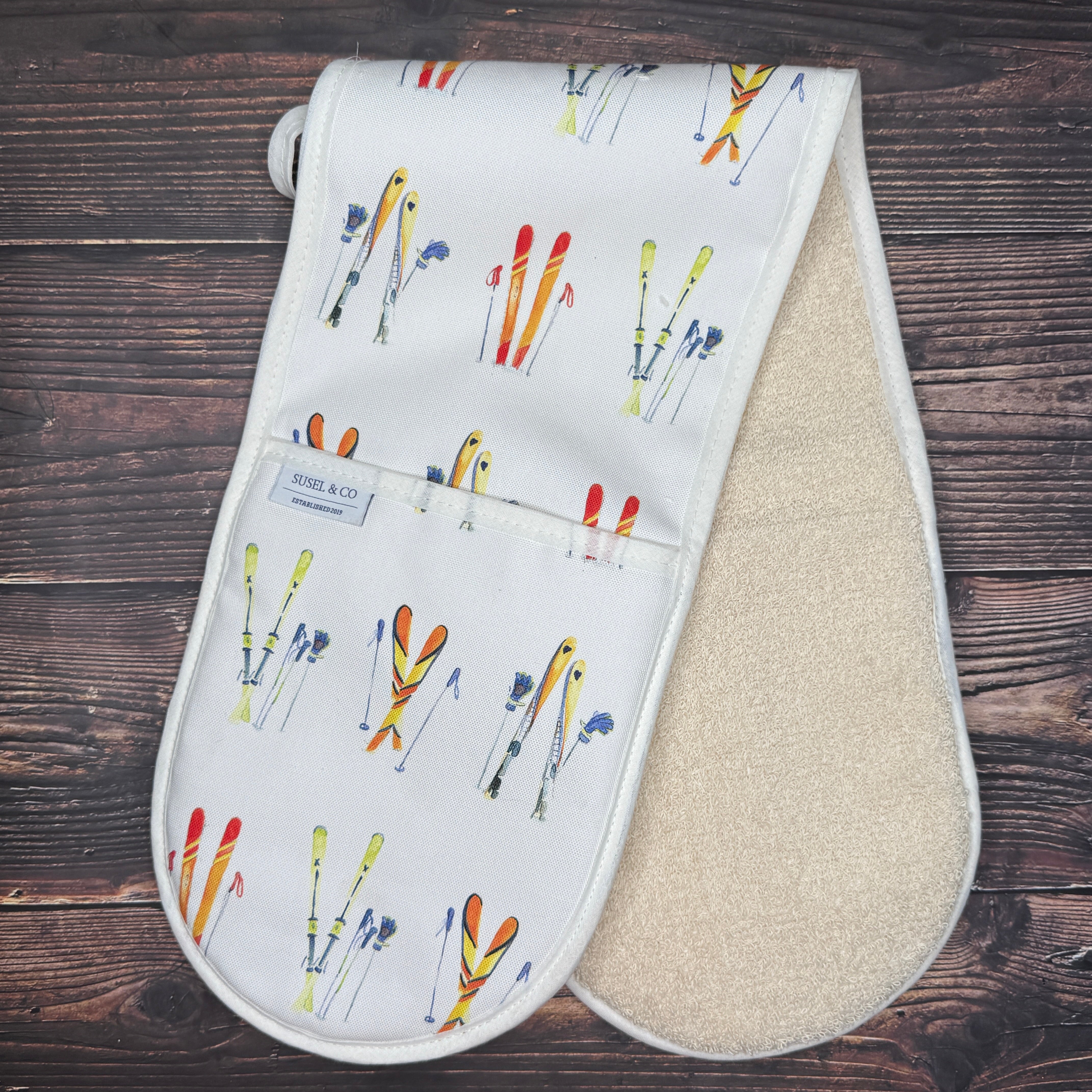 Ski Season double oven gloves hanging in a kitchen