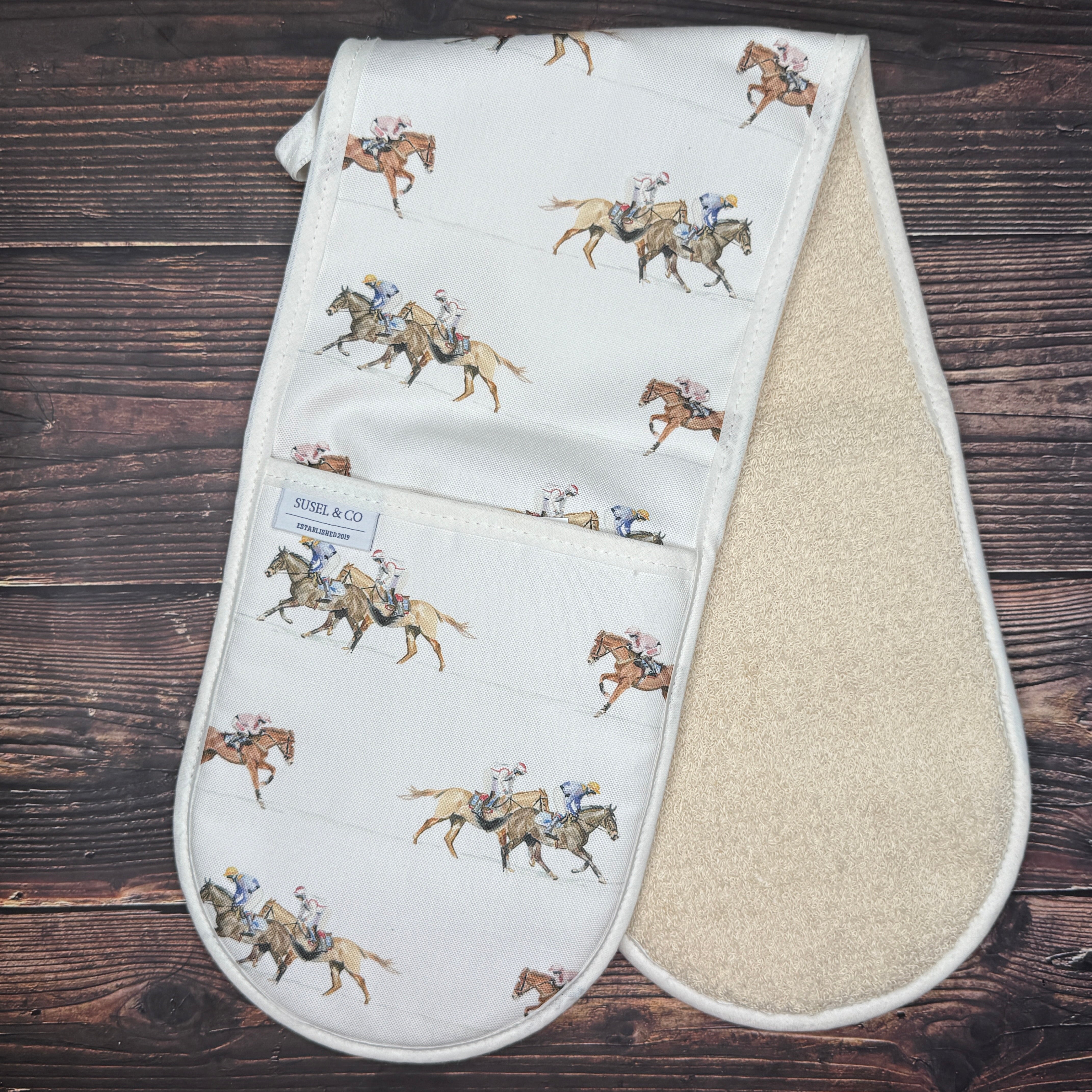 Race Day double oven gloves hanging in a kitchen