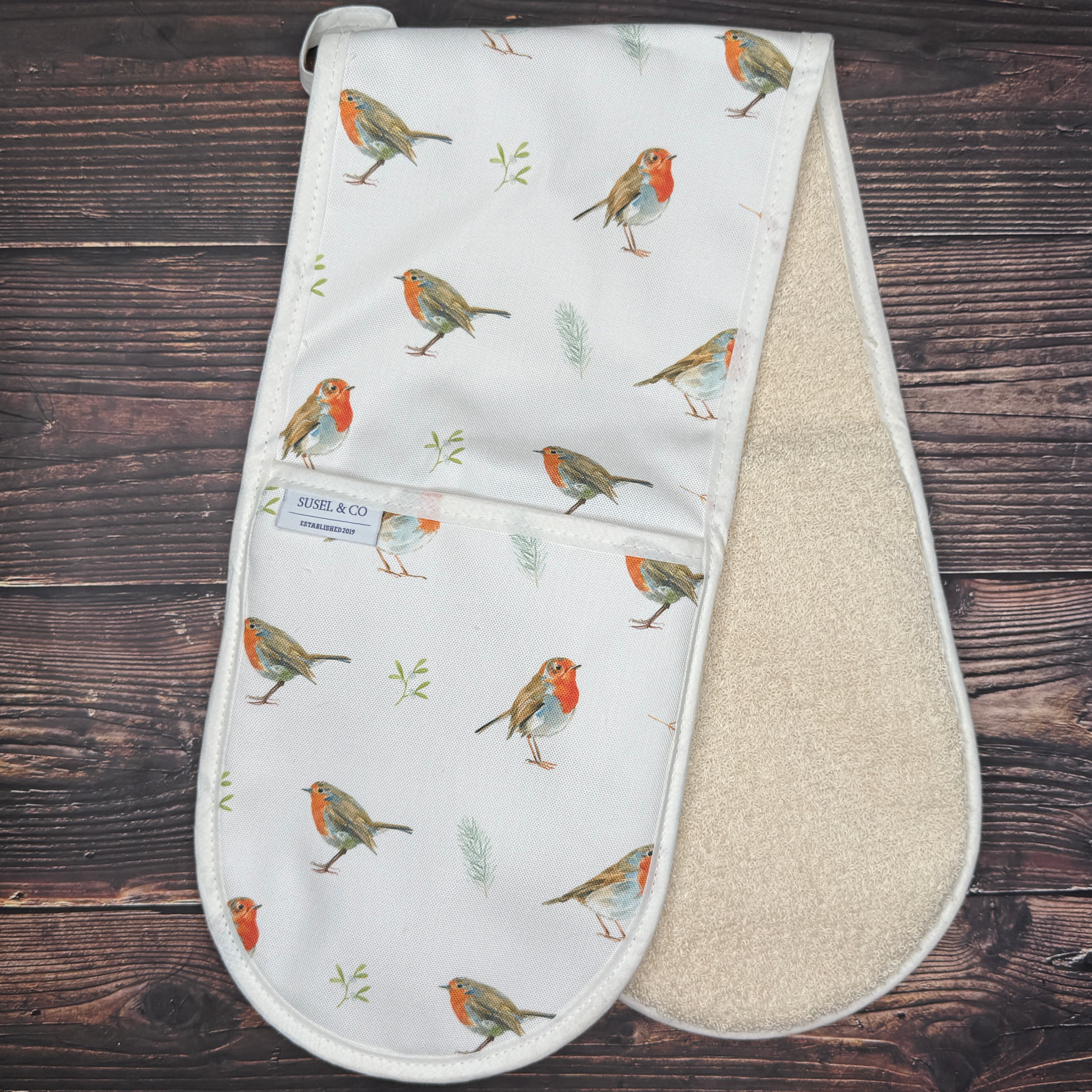 Festive Robin double oven gloves hanging in a kitchen