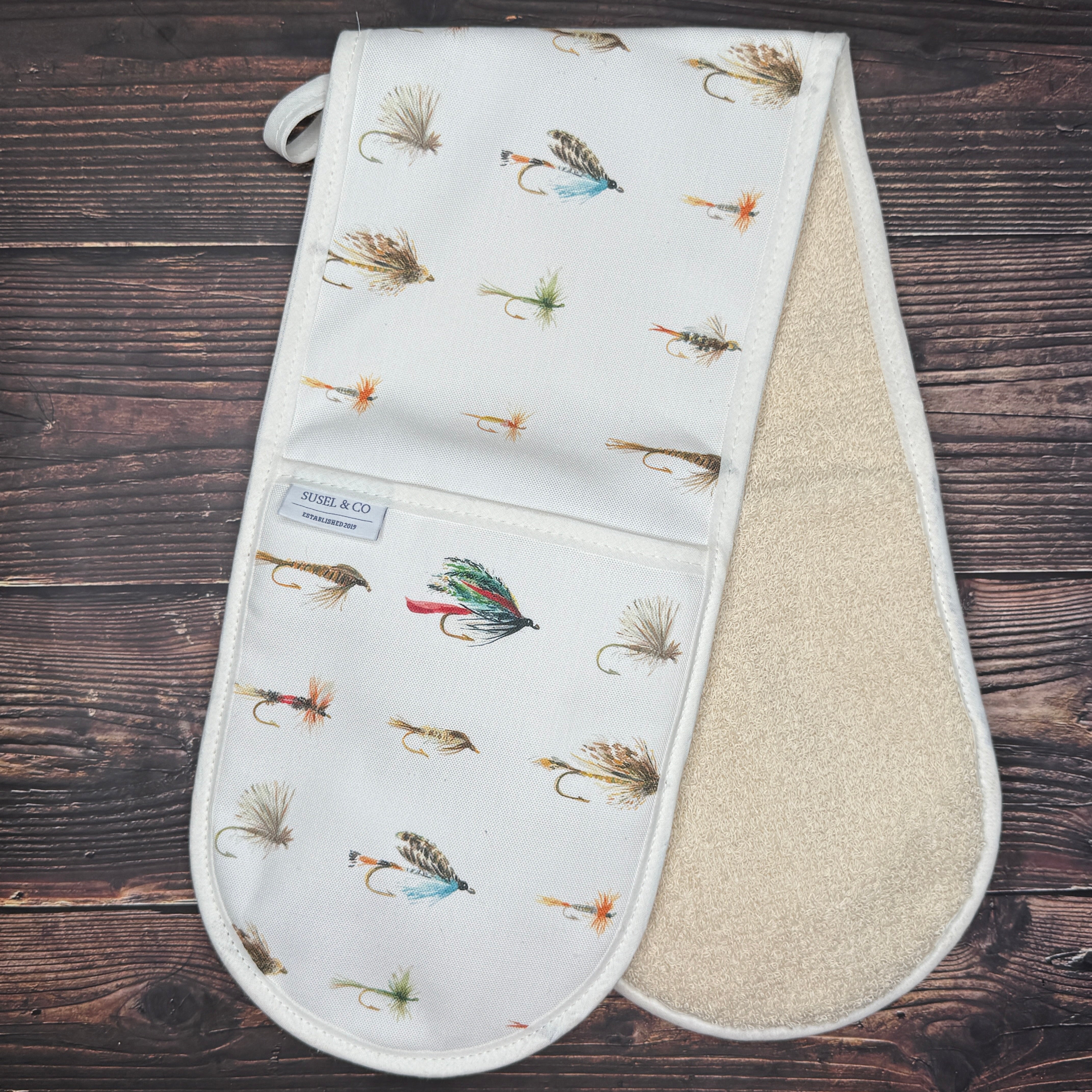 Fishing Flies double oven gloves hanging in a kitchen