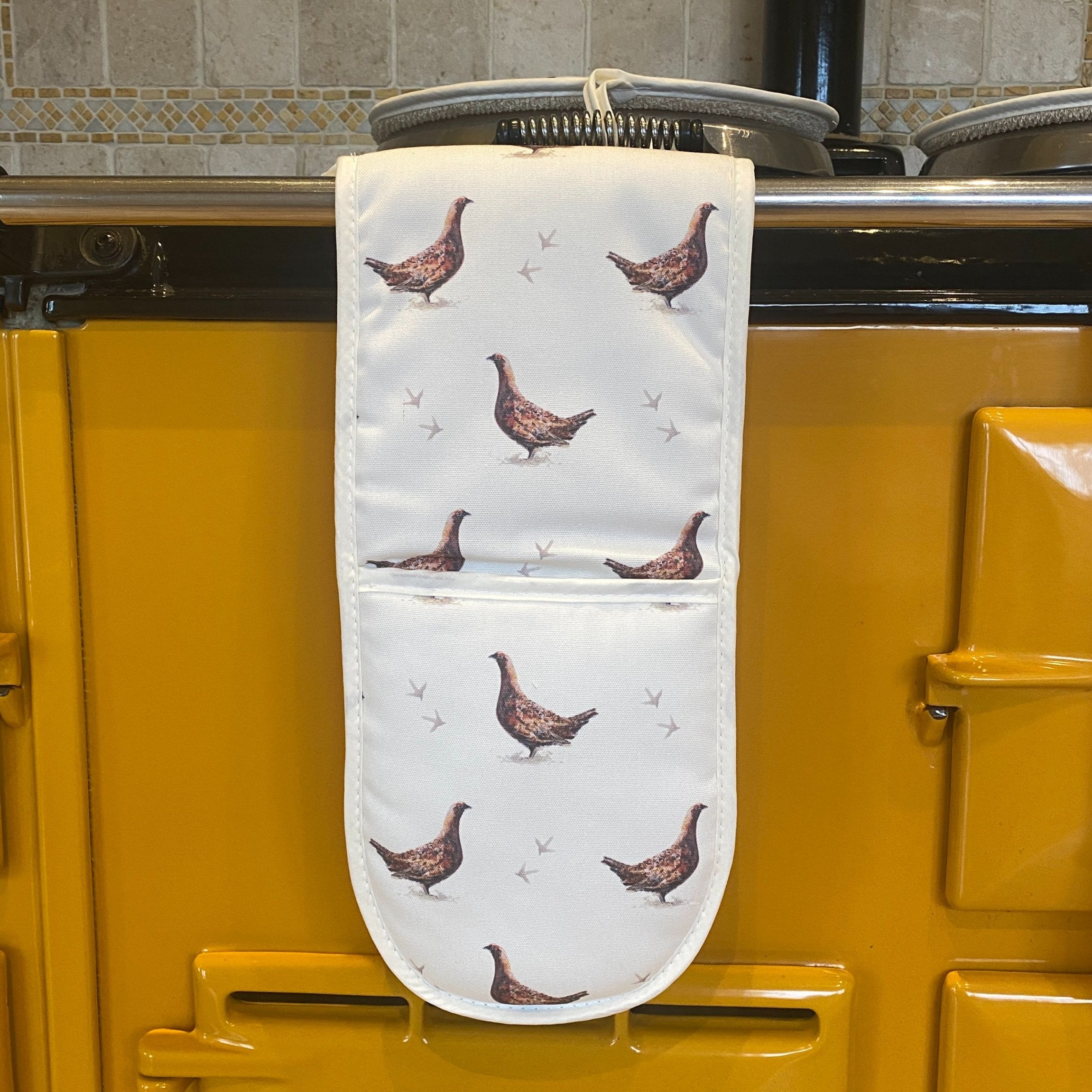 Grouse double oven gloves hanging in a kitchen